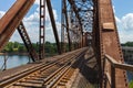 Old rusty truss railroad bridge over the Red River on the border Royalty Free Stock Photo