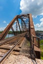 Old rusty truss railroad bridge over the Red River on the border Royalty Free Stock Photo