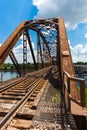 Old rusty truss railroad bridge over the Red River on the border Royalty Free Stock Photo