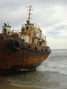 Old rusty tugboat on beach