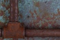 Old rusty valve pipes on rusty metal wall background Royalty Free Stock Photo