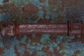 Old rusty valve pipes on rusty metal wall background Royalty Free Stock Photo