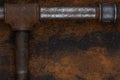 Old rusty valve pipes on rusty metal wall background Royalty Free Stock Photo