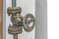 Old rusty valve on a white wall background Royalty Free Stock Photo