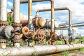 Old rusty valves are latches on the pipeline .