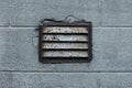 Old rusty ventilation grille on plastered wall Royalty Free Stock Photo