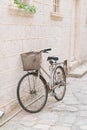 Old rusty vintage bicycle leaning against a stone wall Royalty Free Stock Photo