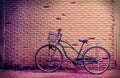 Old rusty vintage bicycle near the concrete wall