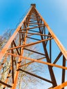 Old rusty watch tower. Old public loudspeakers broadcast on pole