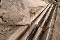 Old rusty water pipes in concrete trench. Underground utility and services pipe lay at the construction site. Repairing Royalty Free Stock Photo