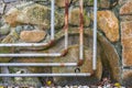 Old and rusty water pipes and pipe joints on stone wall Royalty Free Stock Photo