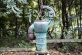 Old rusty water pump in the forest Royalty Free Stock Photo