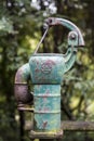 Old rusty water pump in the forest Royalty Free Stock Photo