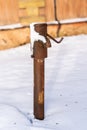 An old rusty water pump on a sunny winter day Royalty Free Stock Photo