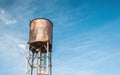 Old rusty water tank on the background of clear blue sky Royalty Free Stock Photo