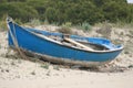 Old rusty and weathered blue boat on the sandy beach Royalty Free Stock Photo