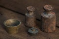 Old rusty weights on a wooden table Royalty Free Stock Photo