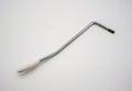 Old rusty whammy bar for electric guitar on white