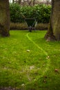 Old rusty wheelbarrow cart in garden Royalty Free Stock Photo