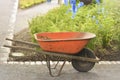 Old rusty wheelbarrow cart in the garden. Working in the garden. Royalty Free Stock Photo