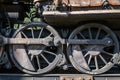 Old rusty wheels of the steam locomotive and the elements of the drive