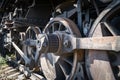 Old rusty wheels of the steam locomotive and the elements of the drive Royalty Free Stock Photo