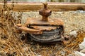 Old rusty winch with ratchet and pawl mechanism and a steel cable rolled up inside