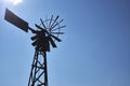 Old rusty wind mill or wind pump opposite clear blue sky Royalty Free Stock Photo