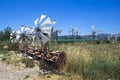 Old rusty windmills on the field. Agriculture in Greece, Crete Royalty Free Stock Photo