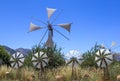 Old rusty windmills on the field. Agriculture in Greece Royalty Free Stock Photo