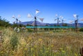 Old rusty windmills on the field. Agriculture in Greece Royalty Free Stock Photo