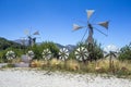 Old rusty windmills on the field. Agriculture in Greece Royalty Free Stock Photo