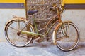 Old rusty women`s bicycle against a plaster wall in a italian street paved of stone Royalty Free Stock Photo