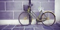 Old rusty women\'s bicycle against a plaster wall in a italian street paved of stone Royalty Free Stock Photo