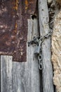 Old rusty wooden door closed with a padlock and chain Royalty Free Stock Photo