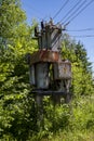 Old rusty working electricity transformer