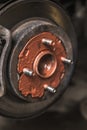 Old rusty worn brake discs are coated with copper grease in a passenger car. Car on a lift in a car service