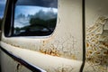 Old rusty wrecked car. Close up of cracked and peeling paint