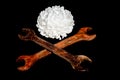 Old rusty wrench and chrysanthemum on a black background Royalty Free Stock Photo