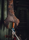 Old rusty wrench spanner tool hanging in abandoned workshop. Royalty Free Stock Photo