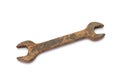 Old rusty wrench on white background