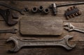 Old rusty wrenches on a wood table, top view