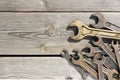 Old rusty wrenches on a wooden table