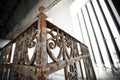 An old rusty wrought-iron railing