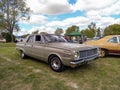 Old 1960s Chrysler Valiant IV four-door sedan parked on green lawn