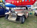 Old black 1937 Ford V8 Deluxe coupe hot rod racer on the lawn. Nature, grass trees. Classic car show Royalty Free Stock Photo