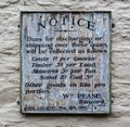 Old 1890`s wooden notice board with fees for landing cargo at Fowey, Cornwall, UK