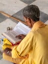 Old sadhu reading scriptures Royalty Free Stock Photo