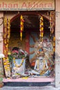 old sadu painted in white ash is meditatingin an arch of the hostel for religious Hindus in Varanasi is collection alms