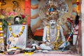 old sadu painted in white ash is meditatingin an arch of the hostel for religious Hindus in Varanasi is collection alms